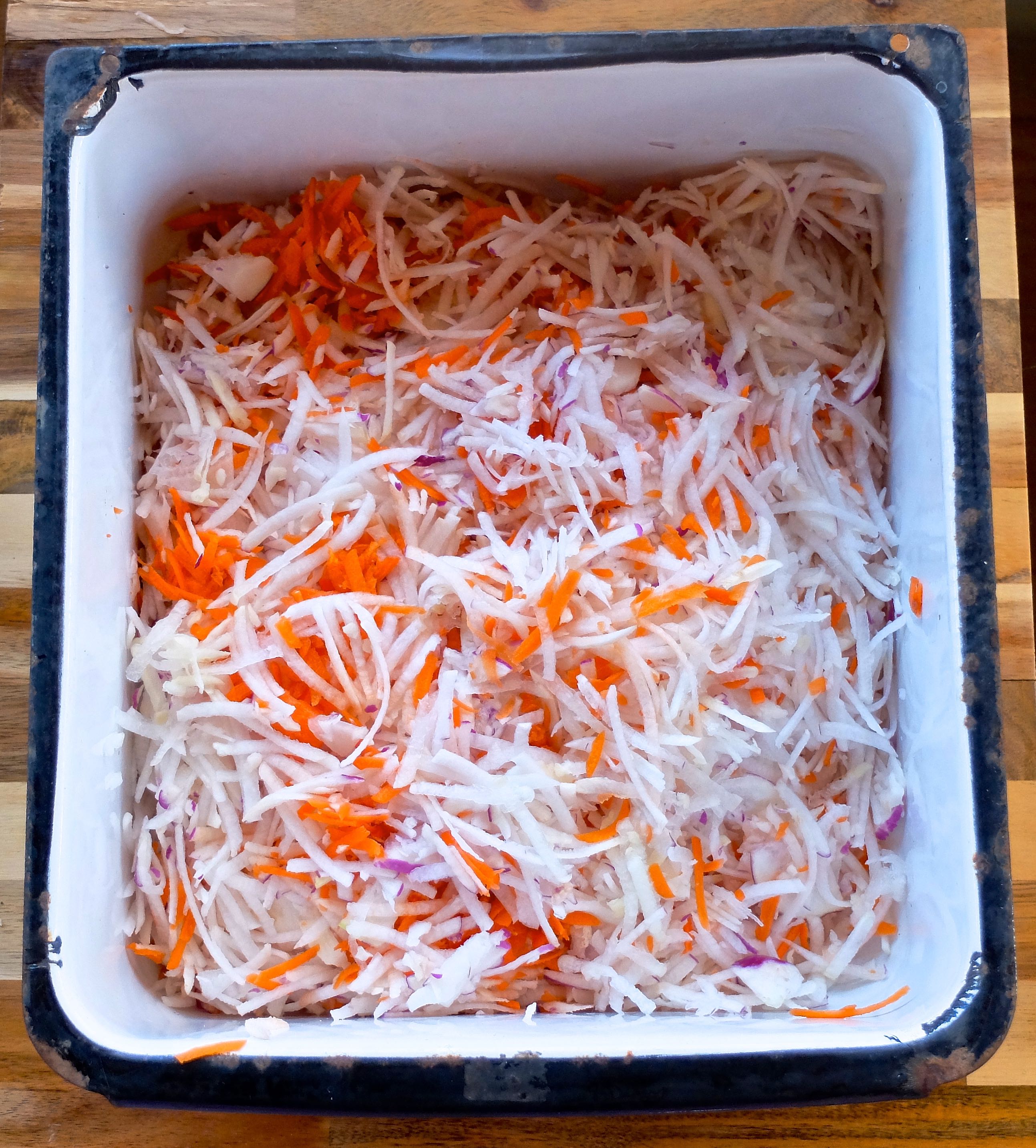 Using a box grater or food processor, shred the vegetables and place in a non-reactive pan. I used carrots and turnips for this batch. 